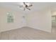 Neutral-toned room featuring tile flooring, a ceiling fan, and ample natural light from a window at 47 Sequoia Loop, Ocklawaha, FL 32179