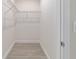 Walk-in closet with wire shelving and wood-look tile floors at 47 Sequoia Loop, Ocklawaha, FL 32179