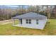 Rear exterior view of home with covered back porch and sliding glass door at 47 Sequoia Loop, Ocklawaha, FL 32179