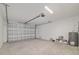 Spacious garage with automatic door opener and white walls at 47 Sequoia Loop, Ocklawaha, FL 32179