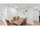 Simple dining area features wood table with seating for four, complemented by elegant wall decor at 506 Clear Rd, Ocala, FL 34472