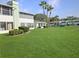 Lush green backyard with community pool, green building, and tropical palm trees at 527 Midway Dr # A, Ocala, FL 34472