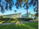 Exterior view of a well-maintained community building surrounded by lush greenery and walkways at 527 Midway Dr # A, Ocala, FL 34472