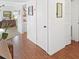 Hallway boasts laminate flooring and white walls, leading to the living area at 527 Midway Dr # A, Ocala, FL 34472