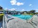 Community pool with ample seating, umbrellas, and clear water, surrounded by well-kept buildings at 527 Midway Dr # A, Ocala, FL 34472