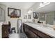 Beautiful bathroom featuring double sinks with granite countertops and large framed horse artwork at 5488 Nw 61St Ave, Ocala, FL 34482