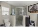 Bathroom featuring a glass enclosed shower, a toilet, and a framed horse artwork at 5488 Nw 61St Ave, Ocala, FL 34482