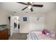 Bright bedroom with a ceiling fan and a closet with white doors at 5488 Nw 61St Ave, Ocala, FL 34482