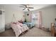 Bright ' bedroom with carpeted floors, two beds, and a window with pink curtains at 5488 Nw 61St Ave, Ocala, FL 34482