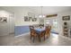 Bright dining room features tiled floors, a blue accent wall, and a door to the backyard at 5488 Nw 61St Ave, Ocala, FL 34482