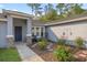 Inviting front entry with stone accents, decorative plants, and a cozy seating area at 5488 Nw 61St Ave, Ocala, FL 34482