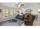 Cozy living room with a ceiling fan, a comfortable seating area, and a piano at 5488 Nw 61St Ave, Ocala, FL 34482