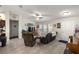 Bright living room features a ceiling fan, tile floors, neutral paint, and comfortable seating at 5488 Nw 61St Ave, Ocala, FL 34482