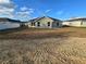 A spacious backyard showing the single story light gray home at 5500 Sw 151St Street Rd, Ocala, FL 34473