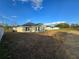 Home's backyard featuring sodded grass, surrounded by neighboring homes, creating a relaxing outdoor space at 5500 Sw 151St Street Rd, Ocala, FL 34473