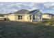 Home's backyard featuring sodded grass, with a view of the home's exterior and surrounding landscape at 5500 Sw 151St Street Rd, Ocala, FL 34473