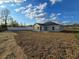 A spacious backyard showing the single story light gray home at 5500 Sw 151St Street Rd, Ocala, FL 34473