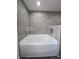 Close-up of modern bathroom featuring a luxurious tub and shower with stone-like tile and pebble floor at 5500 Sw 151St Street Rd, Ocala, FL 34473