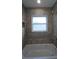 Bathroom with a large soaking tub and tiled surround at 5500 Sw 151St Street Rd, Ocala, FL 34473