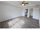 Bedroom with ensuite bathroom and walk-in closet, wood-look flooring, ceiling fan, and recessed lighting at 5500 Sw 151St Street Rd, Ocala, FL 34473