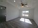 Bright bedroom with modern wood flooring, recessed lighting, ceiling fan, and large window at 5500 Sw 151St Street Rd, Ocala, FL 34473