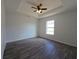 Bedroom featuring tray ceiling, ceiling fan, vinyl plank flooring, and natural light at 5500 Sw 151St Street Rd, Ocala, FL 34473