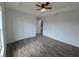 Spacious bedroom featuring luxury vinyl plank flooring, ceiling fan, and walk-in closet at 5500 Sw 151St Street Rd, Ocala, FL 34473