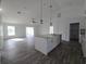 Kitchen with an island, granite counters, wood flooring and stainless steel appliances at 5500 Sw 151St Street Rd, Ocala, FL 34473