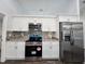 Kitchen featuring stainless steel appliances, granite countertops, and white cabinetry at 5500 Sw 151St Street Rd, Ocala, FL 34473