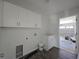 Well-lit laundry room featuring white cabinetry and utility connections at 5500 Sw 151St Street Rd, Ocala, FL 34473