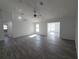 Spacious living area with abundant natural light, ceiling fan, and wood-look floors at 5500 Sw 151St Street Rd, Ocala, FL 34473