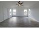 Inviting living room with wood-look floors, a ceiling fan, and ample natural light at 5500 Sw 151St Street Rd, Ocala, FL 34473