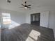 Open living area with wood-look flooring, a ceiling fan, and natural light at 5500 Sw 151St Street Rd, Ocala, FL 34473