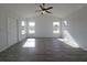 Bright living room with vaulted ceilings, wood-look floors, and multiple windows at 5500 Sw 151St Street Rd, Ocala, FL 34473