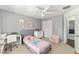 Bedroom featuring a ceiling fan and decorated with flower art and pink furniture at 5910 Sw 89Th St, Ocala, FL 34476