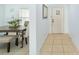 Hallway view with tile flooring, dining area to the left, and entrance door to the right at 5910 Sw 89Th St, Ocala, FL 34476