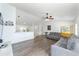 Bright living room featuring wood-look floors and a large sectional sofa at 5910 Sw 89Th St, Ocala, FL 34476