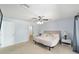 Bright main bedroom with neutral tones, ceiling fan, and ensuite bathroom at 5910 Sw 89Th St, Ocala, FL 34476