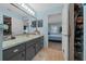 Bathroom featuring tiled floors, a large vanity, and an attached closet at 6196 Sw 84Th Place Rd, Ocala, FL 34476