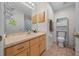 Cozy bathroom featuring a wood vanity, tiled floor, and ample storage space at 6196 Sw 84Th Place Rd, Ocala, FL 34476