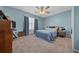 This bedroom has a ceiling fan and large windows that provide natural light at 6196 Sw 84Th Place Rd, Ocala, FL 34476