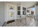 Inviting front porch with tiled floor and seating area for relaxation at 6196 Sw 84Th Place Rd, Ocala, FL 34476