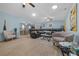 Bright living room flowing into the dining area, featuring hardwood floors and a large leather sectional at 6196 Sw 84Th Place Rd, Ocala, FL 34476