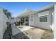 Cozy covered patio with outdoor seating, an outdoor hot tub, and a fenced-in yard provides a relaxing space at 6196 Sw 84Th Place Rd, Ocala, FL 34476