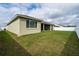 Expansive backyard featuring a well-maintained lawn, a white fence, and screened in patio at 6367 Sw 70Th Cir, Ocala, FL 34474