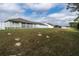 A large grassy backyard features a white picket fence, offering privacy and plenty of space at 6367 Sw 70Th Cir, Ocala, FL 34474