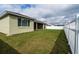 Large backyard featuring a manicured lawn, a white privacy fence, and a screened patio at 6367 Sw 70Th Cir, Ocala, FL 34474