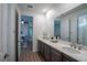 Modern bathroom with double vanity, white quartz countertops and access to additional rooms at 6367 Sw 70Th Cir, Ocala, FL 34474