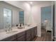 Stylish bathroom featuring a double sink vanity, neutral color palette, and access to a shower and bedroom at 6367 Sw 70Th Cir, Ocala, FL 34474