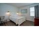 A cozy bedroom featuring a queen-size bed, hardwood floors, and ample natural light at 6367 Sw 70Th Cir, Ocala, FL 34474